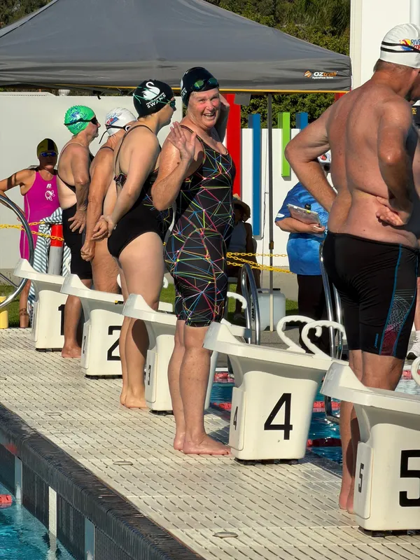 Swimmers waiting behind the starting blocks