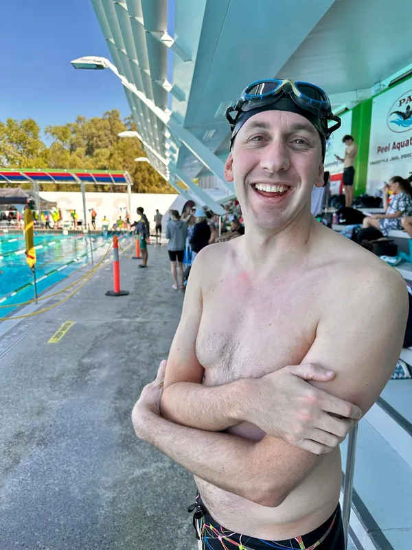 Swimmer smiling with goggles on head